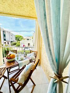 a balcony with a table and chairs and a large window at Bonito apartamento con piscina a 50 metros de la playa! in Port de Pollensa +24 photos