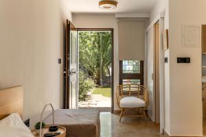 a living room with a door open to a yard at Alkis Guest House by AegianKazarte in Kapótidhes