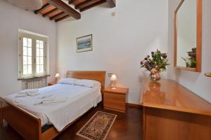 A bed or beds in a room at Tenuta Santa Colomba - Happy Rentals