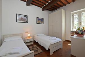 A bed or beds in a room at Tenuta Santa Colomba - Happy Rentals