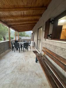 un patio con panchine, tavolo e sedie di Mani Spot in Almiro a Kyparissos