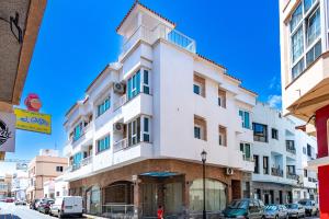 a white building on the side of a street at Calas Beach Corralejo in Corralejo