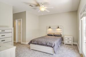 a bedroom with a bed and a ceiling fan at Bright Biloxi Condo Walk to the Beach! in Biloxi +20 photos