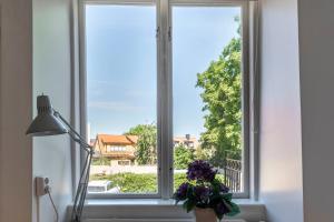 une fenêtre avec un vase de fleurs devant elle dans l'établissement Beautiful 3 bedroom apartment in heart of Visby, à Visby