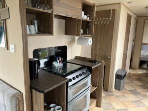 a kitchen with a stove and a counter top at A fully equiped caravan Marton mere haven in Blackpool