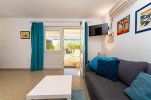 a living room with a couch and a table at Apartments Crnko, 50m from the beach with free parking and drinkable tap water in Vir