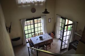 a dining room with a table and two windows at Aya Bungalows in Colón