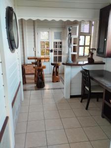 a kitchen with a table and a counter top at Le pain de sucre in Marigot