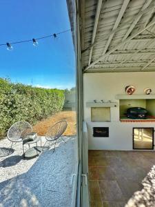 a patio with two chairs and a table and a stove at GREEN ESTATE villas in Arménoi