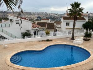 a large swimming pool in the middle of a house at La Marquesa Golf 3 bedroom Detached Villa in Ciudad Quesada