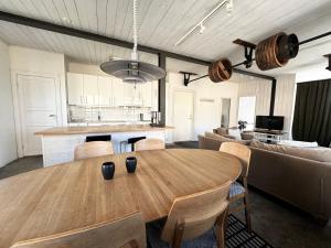 a kitchen and a dining room with a wooden table at Wonderfull 2-Bedroom apartment in Visby in Visby