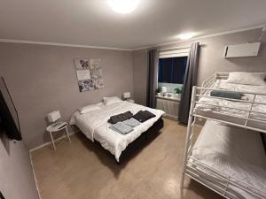 a bedroom with two bunk beds and a window at Bakgården Mariestad in Mariestad +16 photos