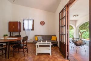 a living room with a couch and a table at Villino in Torre delle Stelle +18 photos