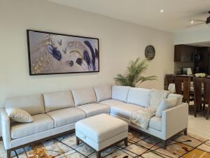 a living room with a couch and a table at Casa Paraiso in Nuevo Vallarta 