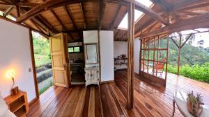 a large room with wooden flooring and wooden ceilings at Moraia Bioconecta Cabaña El Porvenir in Córdoba