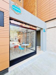 a restaurant with a table and chairs in a window at Bilbao ROOMS & KITCHEN Santutxu in Bilbao