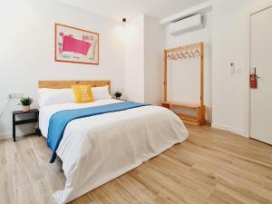 a bedroom with a large bed and a wooden floor at Bilbao ROOMS & KITCHEN Santutxu in Bilbao