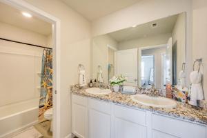 a bathroom with two sinks and a large mirror at San Antonio Home with Fenced-In Yard Steps to Park! in San Antonio +24 photos