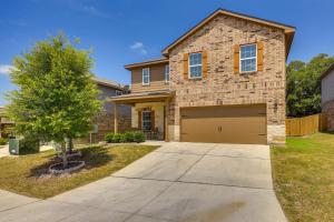 a brick house with a garage and a tree at San Antonio Home with Fenced-In Yard Steps to Park! in San Antonio