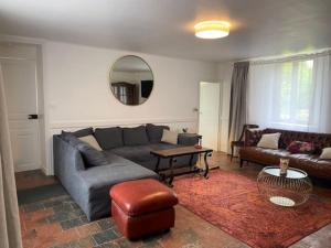 a living room with a couch and a table at Le Domaine Des Roses Normandie Foulognes in Foulognes