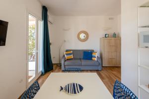 a living room with a couch and a window at Villa Leomaris in Torre dell'Orso