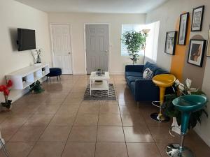 a living room with a couch and a tv at Rest in Vegas in Las Vegas