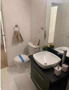 a bathroom with a white toilet and a sink at Rest in Vegas in Las Vegas