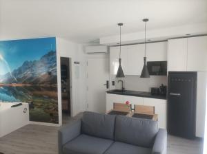 a living room with a couch and a kitchen at The Romantic Loft in Béjar