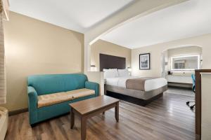 a hotel room with a bed and a couch at Best Western Catalina Inn in Tuscaloosa +17 photos