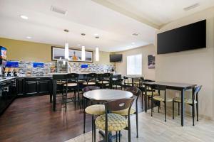 a restaurant with tables and chairs and a bar at Best Western Edgewater Inn in Edgewater