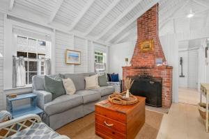 a living room with a couch and a fireplace at 17 Captain Dunbar Road Brewster - Prestons Haven in Brewster