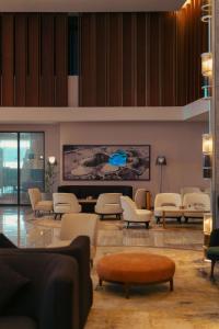 a waiting room with chairs and a large screen at Radisson Blu Hotel Riyadh Convention and Exhibition Center in Riyadh