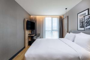 Krevet ili kreveti u jedinici u okviru objekta Radisson Hotel Graz