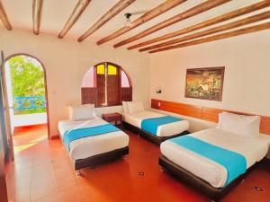 Voodi või voodid majutusasutuse Hotel Pueblito Cafetero toas