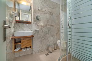 a bathroom with a sink and a shower at Arolithos in Spetses