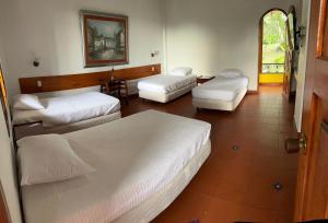 Voodi või voodid majutusasutuse Hotel Pueblito Cafetero toas