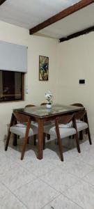 a ping pong table in a room with chairs at Departamentos las Palmeras in Tarapoto +4 photos