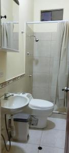 a bathroom with a sink and a toilet and a shower at Departamentos las Palmeras in Tarapoto