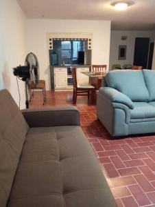 a living room with a couch and a chair at Amplía casa en Jardines Alcalde in Guadalajara