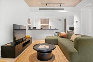 a living room with a couch and a table at Modern, Luxury Retreat with Gym and Pool in Melbourne