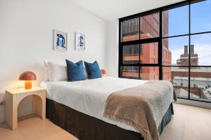 a bedroom with a large bed and a large window at Modern, Luxury Retreat with Gym and Pool in Melbourne