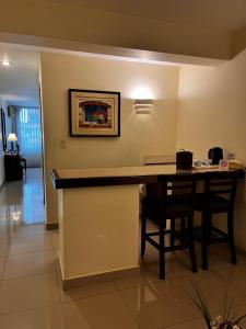 a kitchen with a table and chairs in a room at Hotel Boulevard in Lima