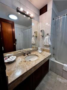 a bathroom with a sink and a shower at Hotel Boulevard in Lima