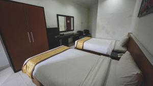 Postel nebo postele na pokoji v ubytování LPP Garden Hotel