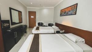 Postel nebo postele na pokoji v ubytování LPP Garden Hotel