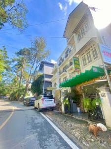 a building with a car parked on the side of a street at Sơn Hùng Hotel Đà Lạt in Da Lat