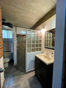 a bathroom with a shower and a sink and a toilet at Villa Palmas #1 One bedroom beach scape apartament in San Francisco