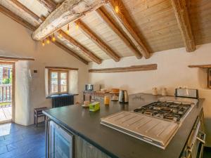 a kitchen with a stove and a counter top at Chalet 17°C restauré, 4 ch, au cœur du vieux Val-d'Isère, grande cheminée, proche pistes, parking, WiFi - FR-1-694-358 in Val dʼIsère