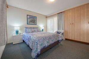 Un dormitorio con una cama grande y una ventana. en Bay Parklands, 62 2 Gowrie Avenue - Wifi, Pool, Tennis, Water Views & Aircon, en Nelson Bay 24 fotos más