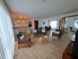 an open living room with furniture and a kitchen at Ventanas de la Patagonia in Esquel